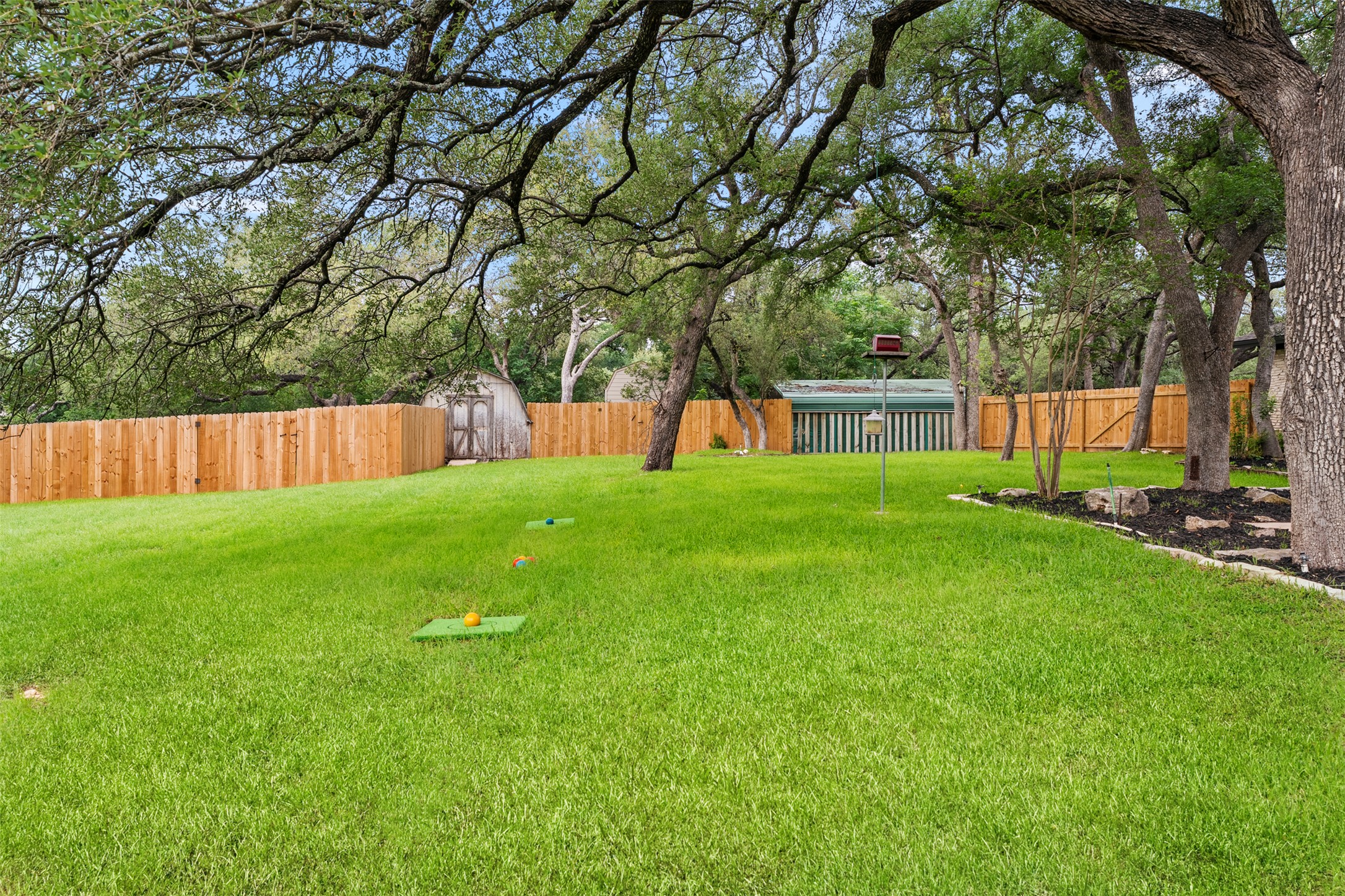 303 West Sequoia Spur Georgetown, TX 78628 - Photo 26 of 34 a view of a backyard with a garden