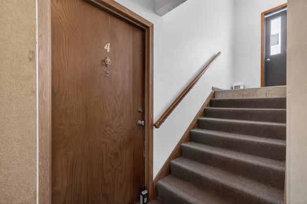 a view of staircase with lots of frames on wall