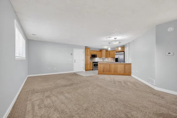 a view of a kitchen with a sink and cabinets