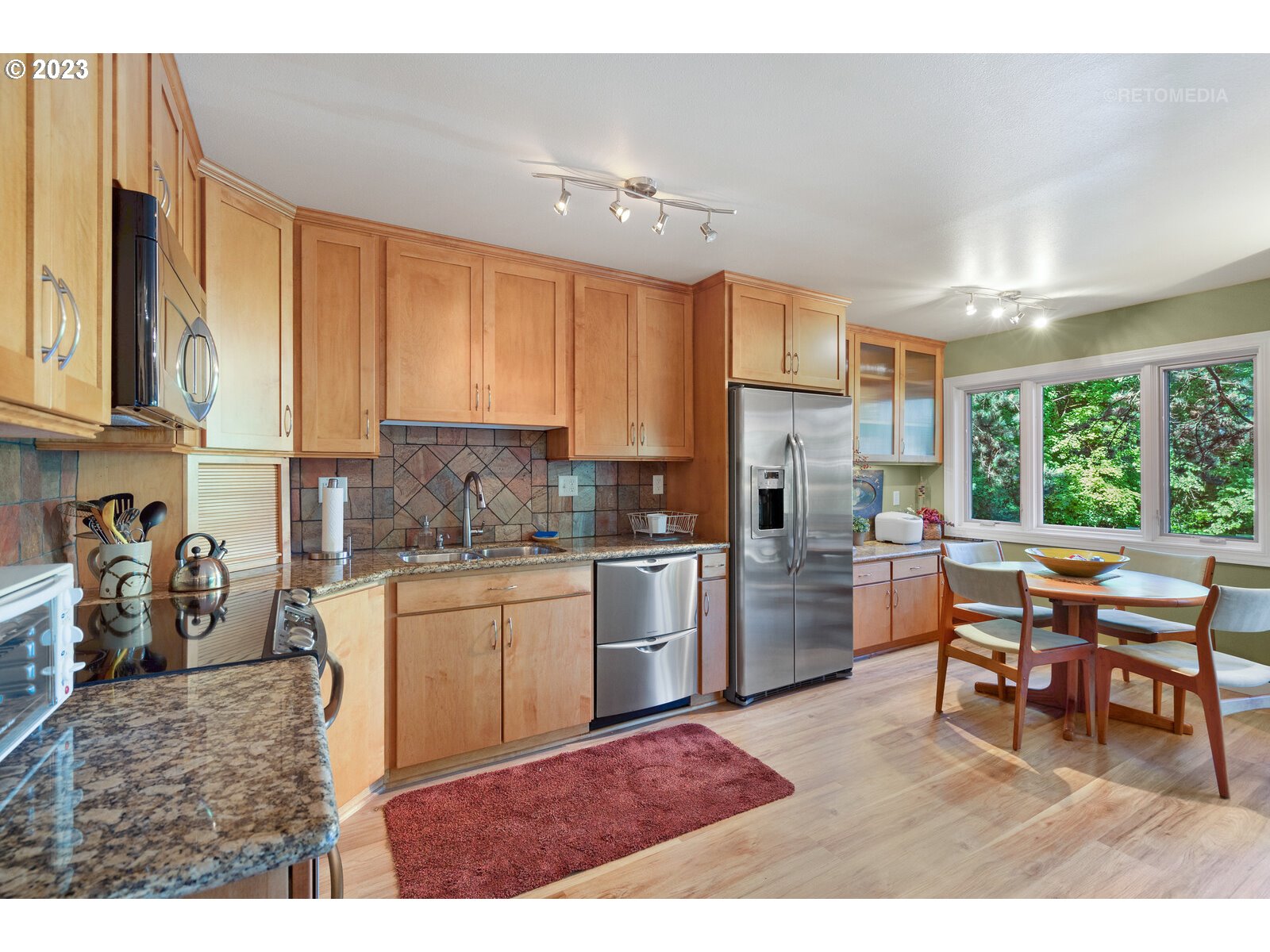 2021 Southwest Main Street, Unit 32 Portland, OR 97205 - Photo 11 of 38 a kitchen with refrigerator and cabinets