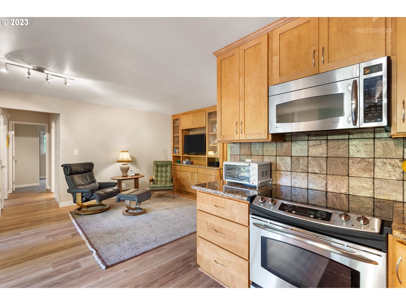 2021 Southwest Main Street, Unit 32 Portland, OR 97205 - Photo 12 of 38 a kitchen with kitchen island a stove a sink and a microwave