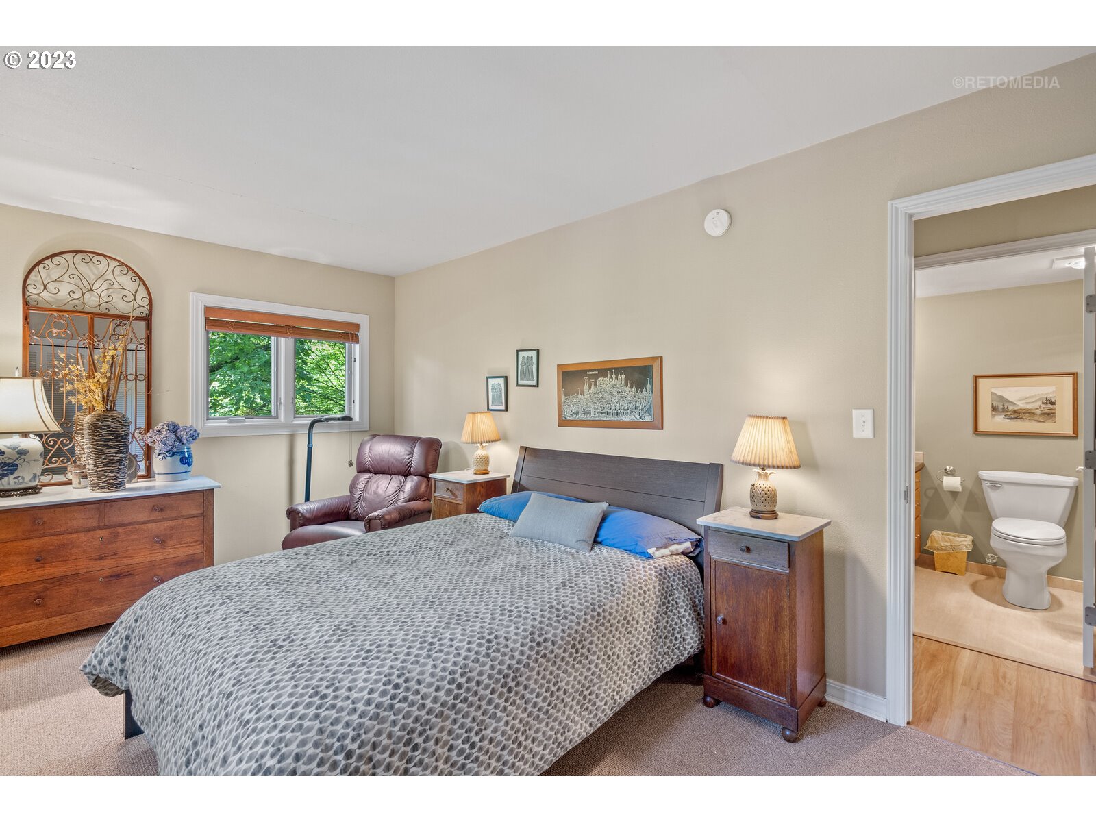2021 Southwest Main Street, Unit 32 Portland, OR 97205 - Photo 16 of 38 a bedroom with a bed a dresser and next to a window