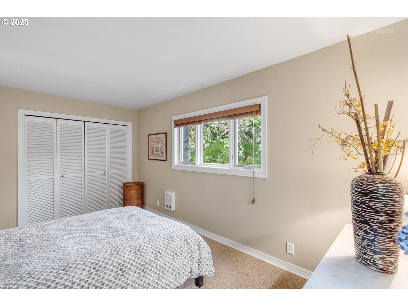 2021 Southwest Main Street, Unit 32 Portland, OR 97205 - Photo 18 of 38 a bedroom with a bed and a chair