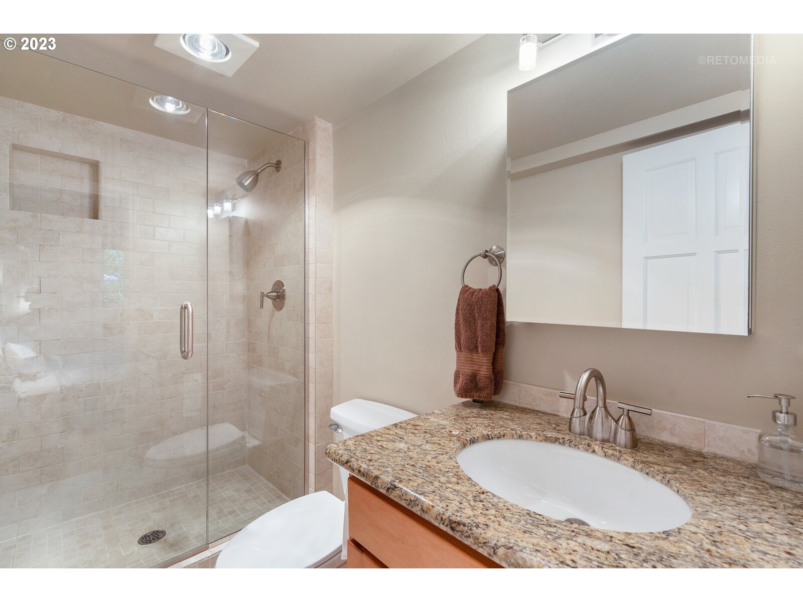 2021 Southwest Main Street, Unit 32 Portland, OR 97205 - Photo 22 of 38 a bathroom with a granite countertop sink a mirror and shower