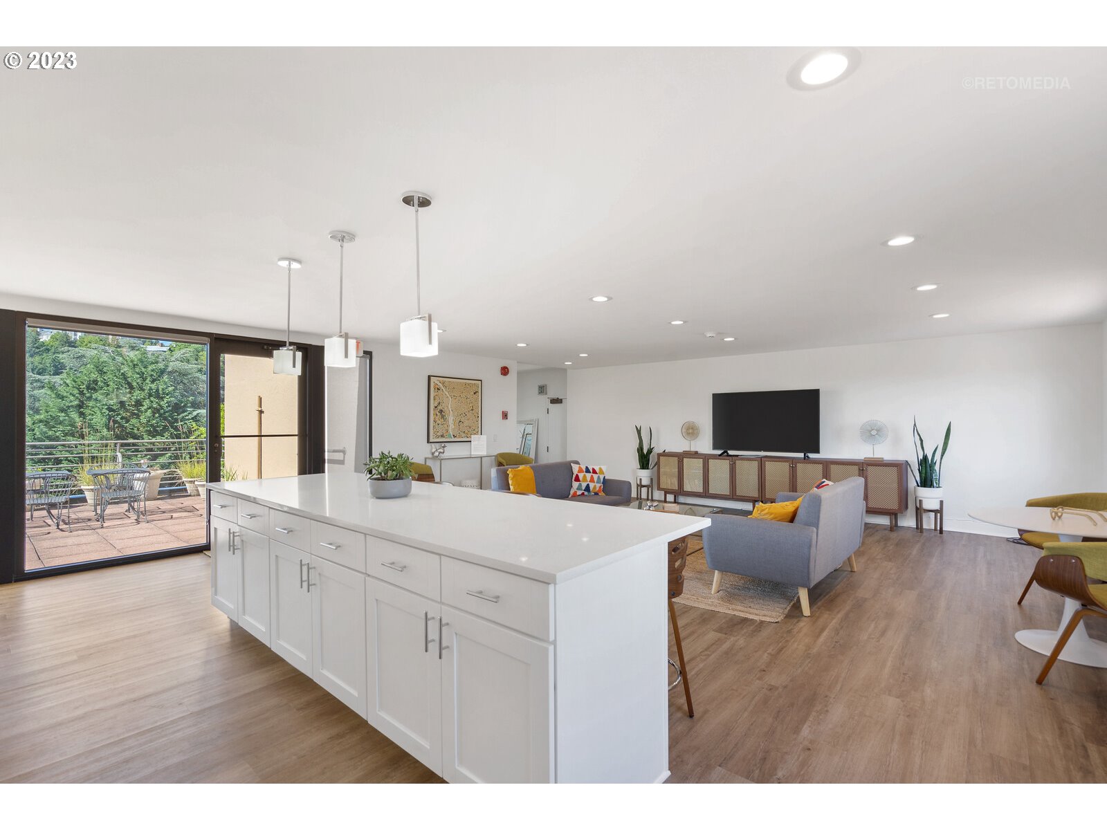 2021 Southwest Main Street, Unit 32 Portland, OR 97205 - Photo 27 of 38 a living room with furniture and a flat screen tv