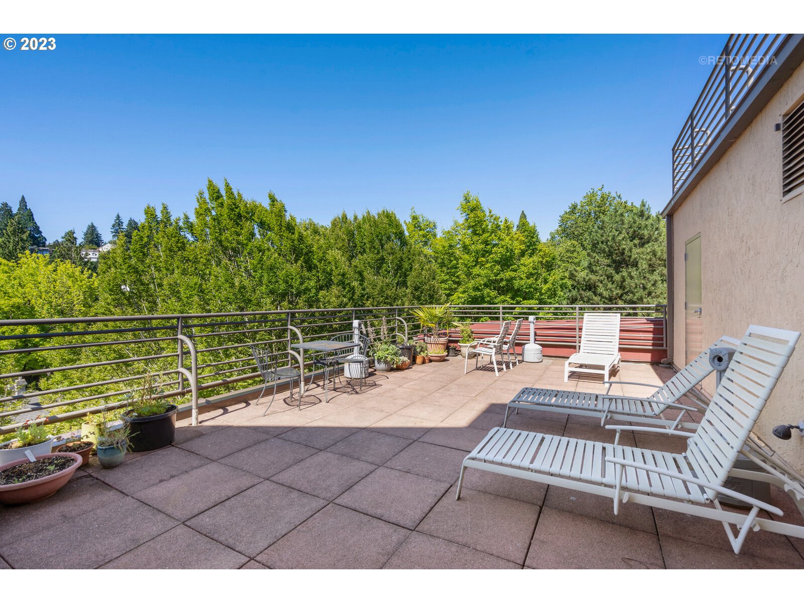 2021 Southwest Main Street, Unit 32 Portland, OR 97205 - Photo 32 of 38 a view of a chairs and table in the terrace