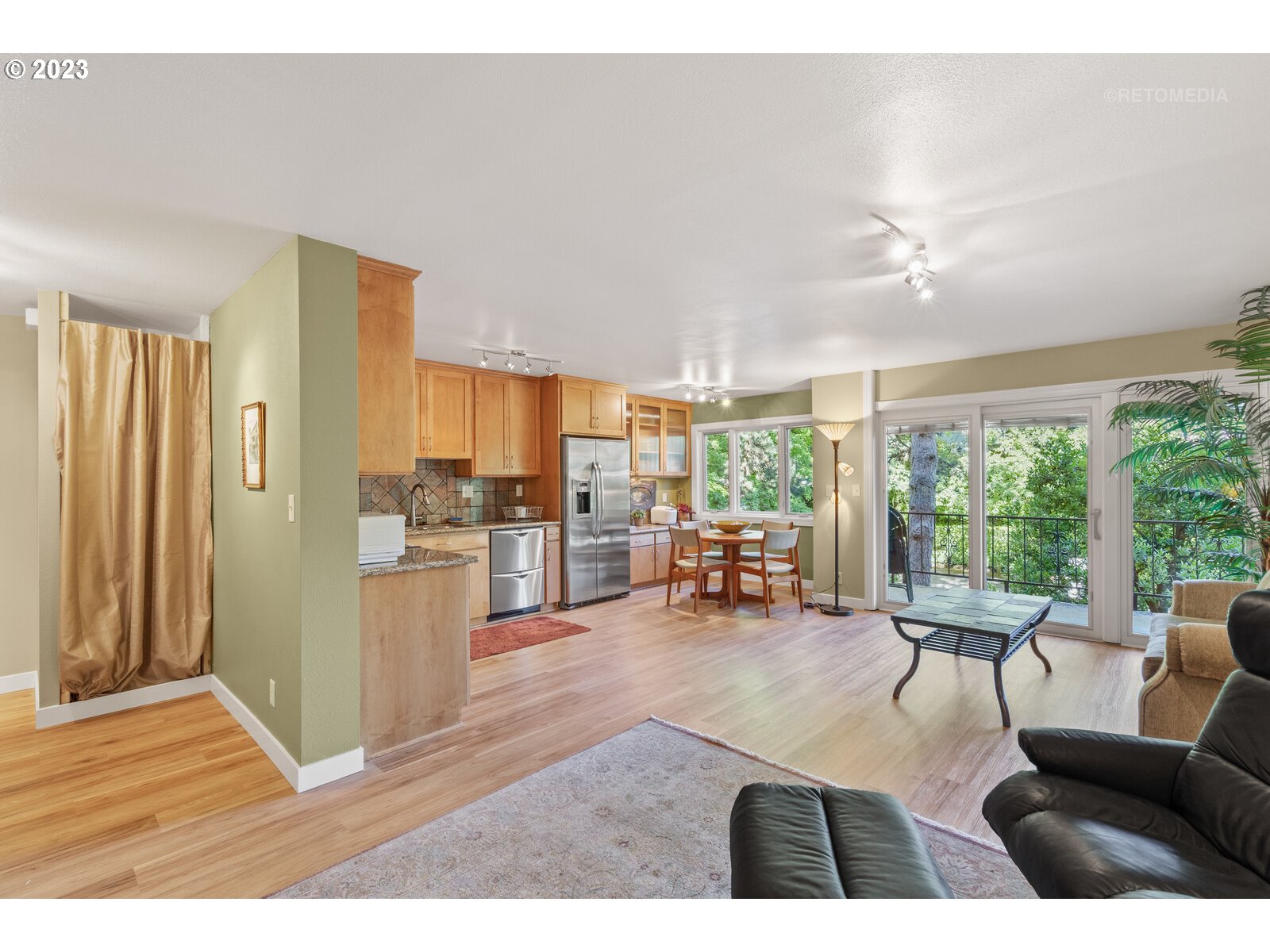 2021 Southwest Main Street, Unit 32 Portland, OR 97205 - Photo 4 of 38 a living room with furniture large window and chairs