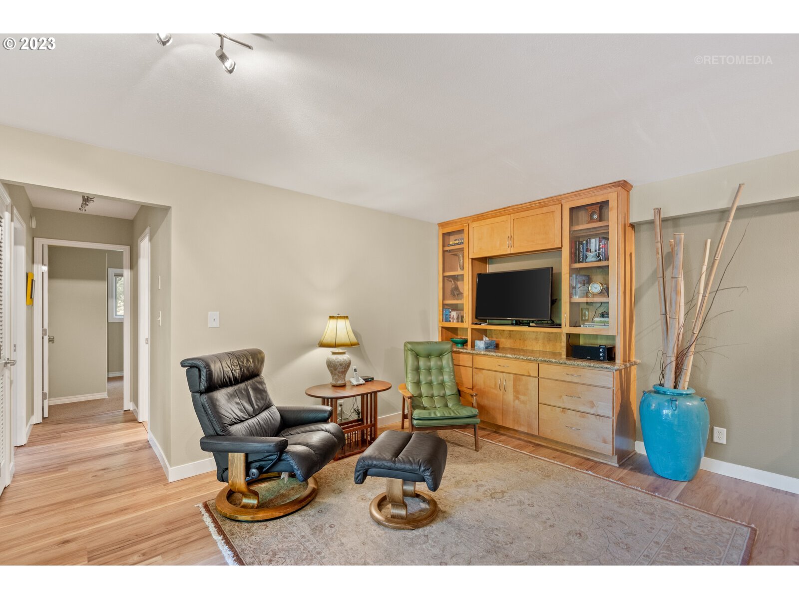2021 Southwest Main Street, Unit 32 Portland, OR 97205 - Photo 5 of 38 a living room with furniture a flat screen tv and a refrigerator