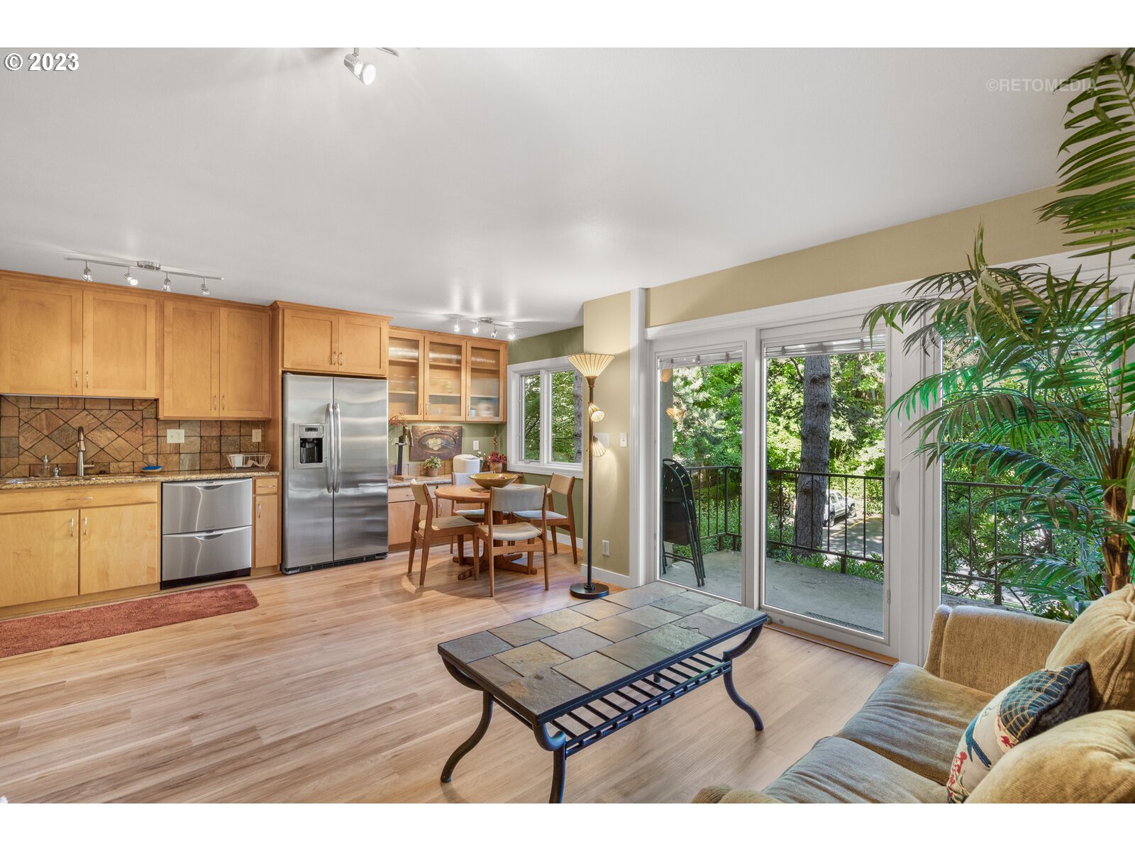 2021 Southwest Main Street, Unit 32 Portland, OR 97205 - Photo 6 of 38 a living room with furniture kitchen view and large windows