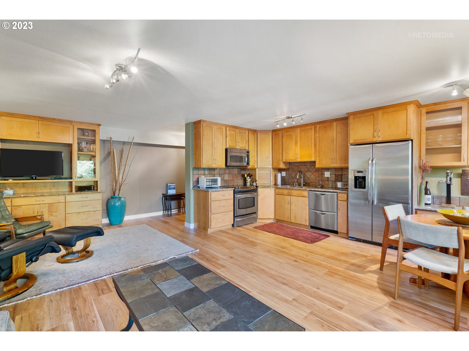 2021 Southwest Main Street, Unit 32 Portland, OR 97205 - Photo 9 of 38 a living room with stainless steel appliances kitchen island granite countertop furniture and a kitchen view
