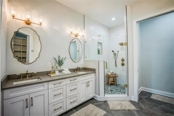 a bathroom with a double vanity sink and a mirror