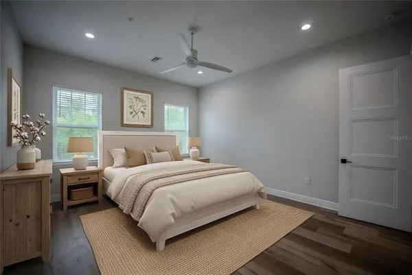 a bedroom with a large bed and a chandelier