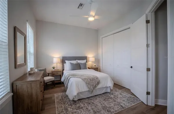 a bedroom with a bed and a mirror