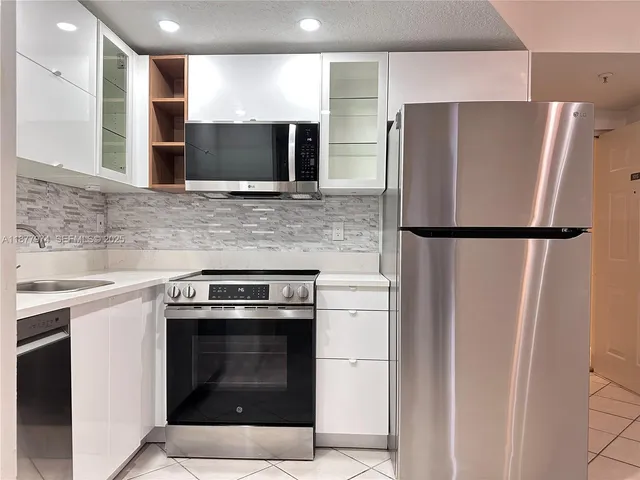 a kitchen with a refrigerator sink and microwave