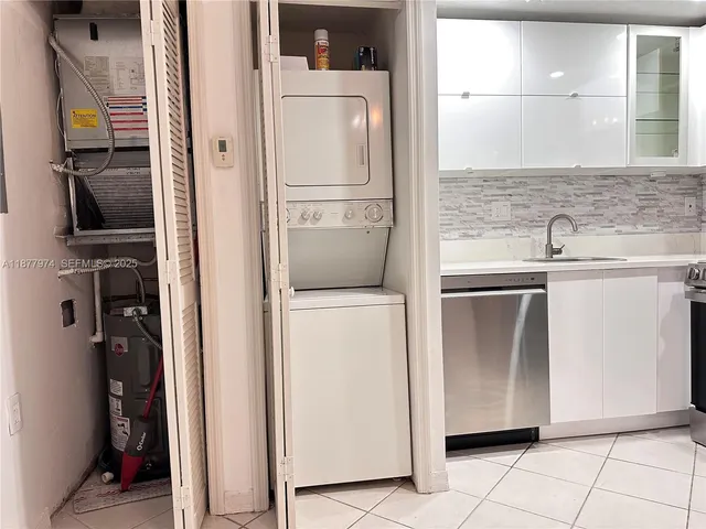 a kitchen with a refrigerator and a sink