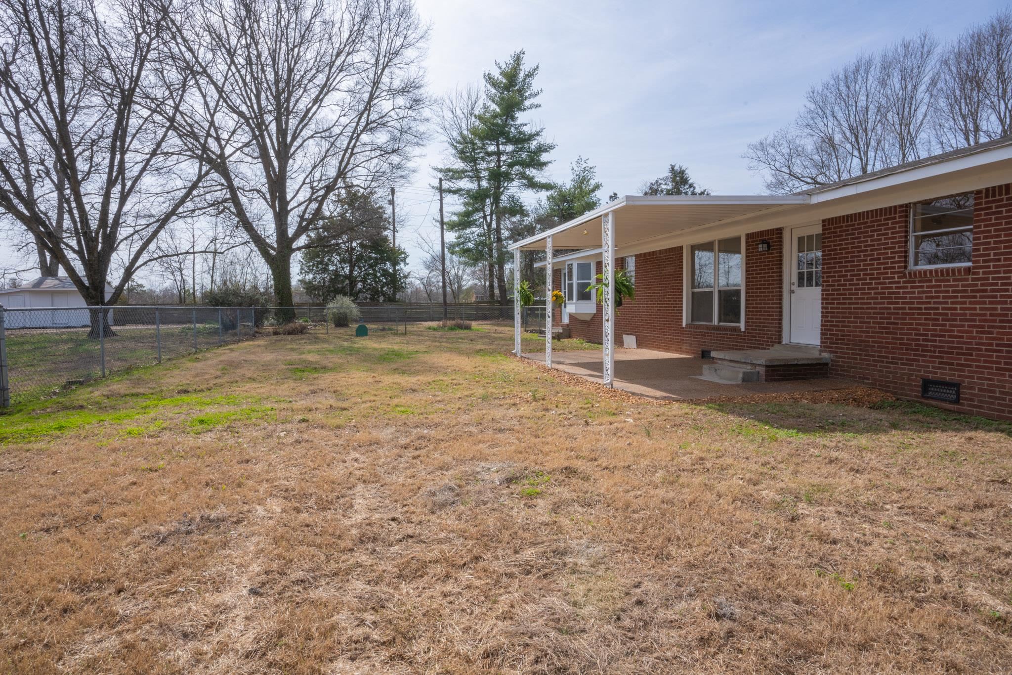 3616 Jack Pond Road Mason, TN 38049 - Photo 21 of 23 a backyard of a house with barbeque oven and outdoor seating