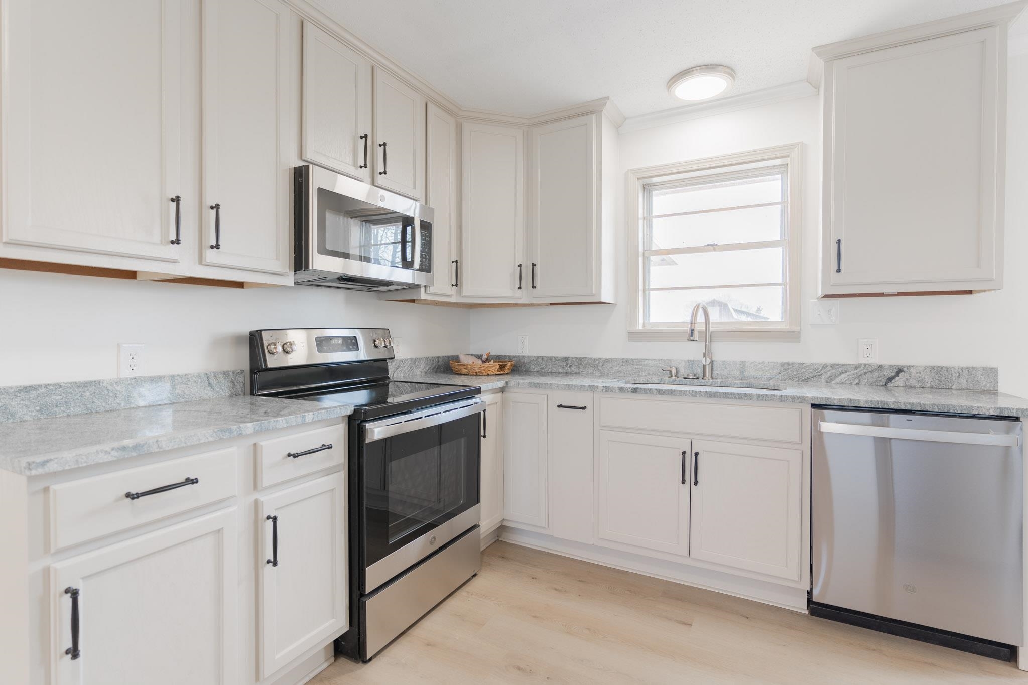 3616 Jack Pond Road Mason, TN 38049 - Photo 6 of 23 a kitchen with stainless steel appliances granite countertop white cabinets a sink and dishwasher