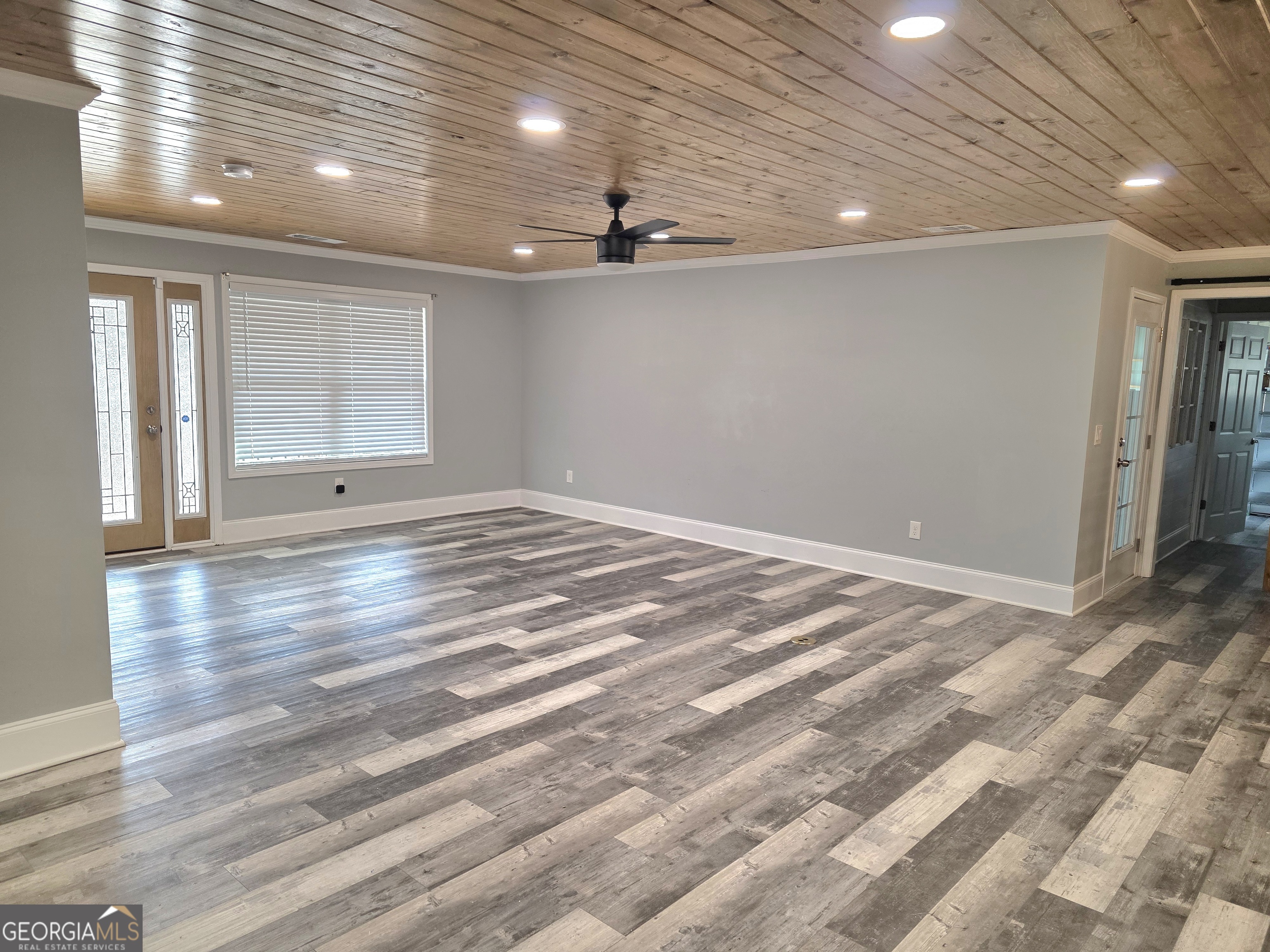 391 Price Street Statham, GA 30666 - Photo 14 of 41 a view of an empty room with window and wooden floor