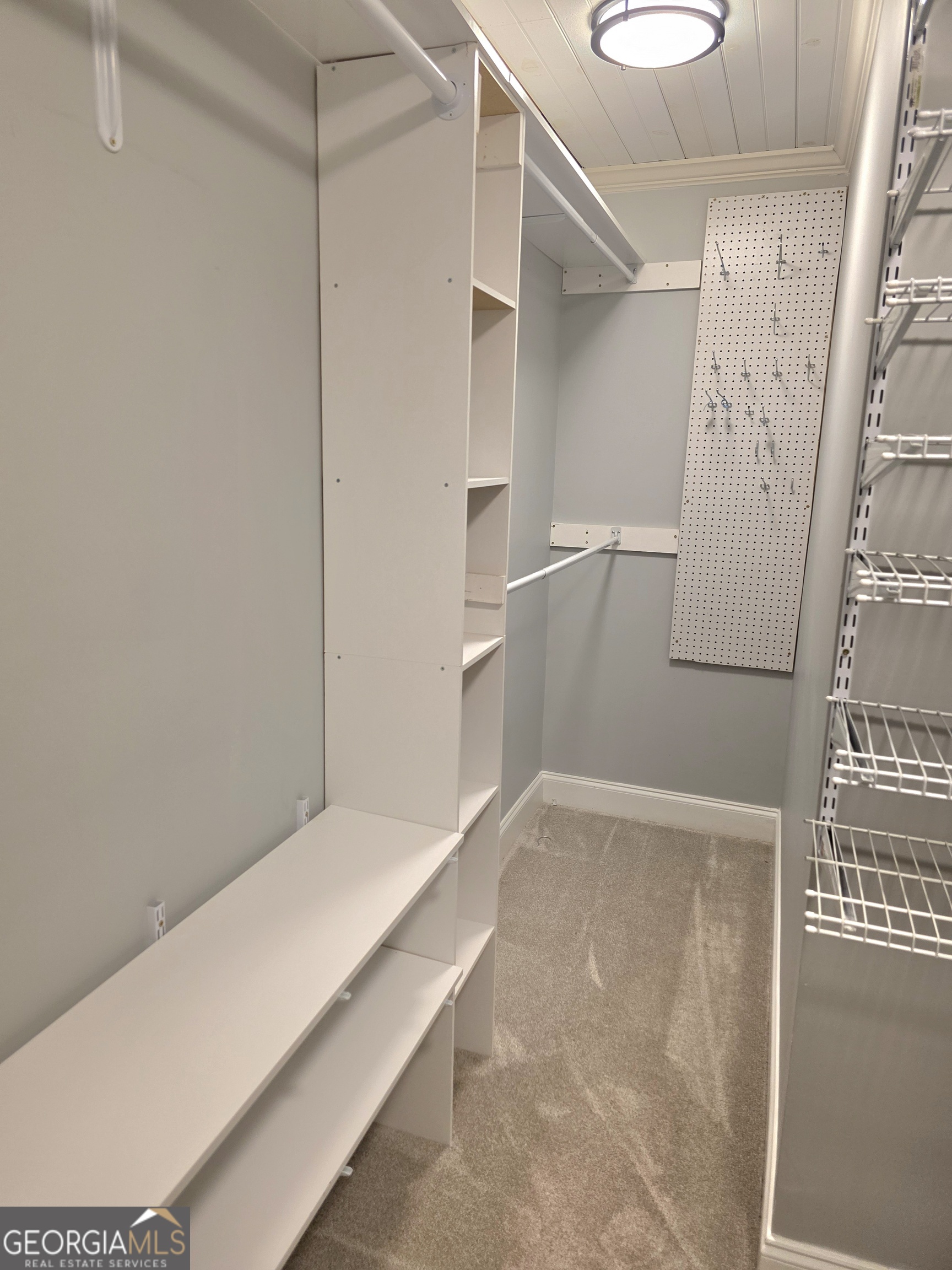 391 Price Street Statham, GA 30666 - Photo 27 of 41 a view of walk in closet with empty racks
