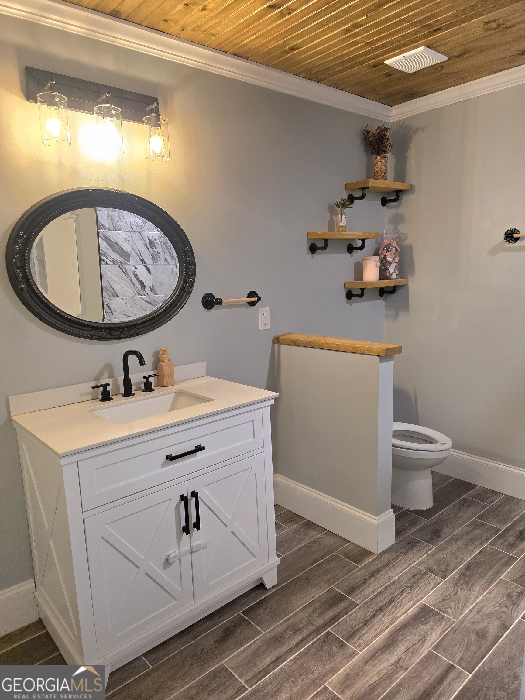 391 Price Street Statham, GA 30666 - Photo 32 of 41 a bathroom with a toilet sink and mirror