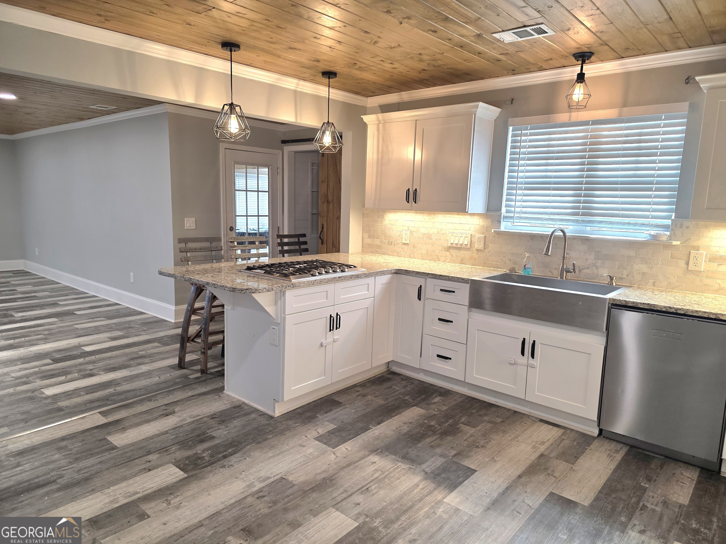 391 Price Street Statham, GA 30666 - Photo 4 of 41 a kitchen with white cabinets and sink