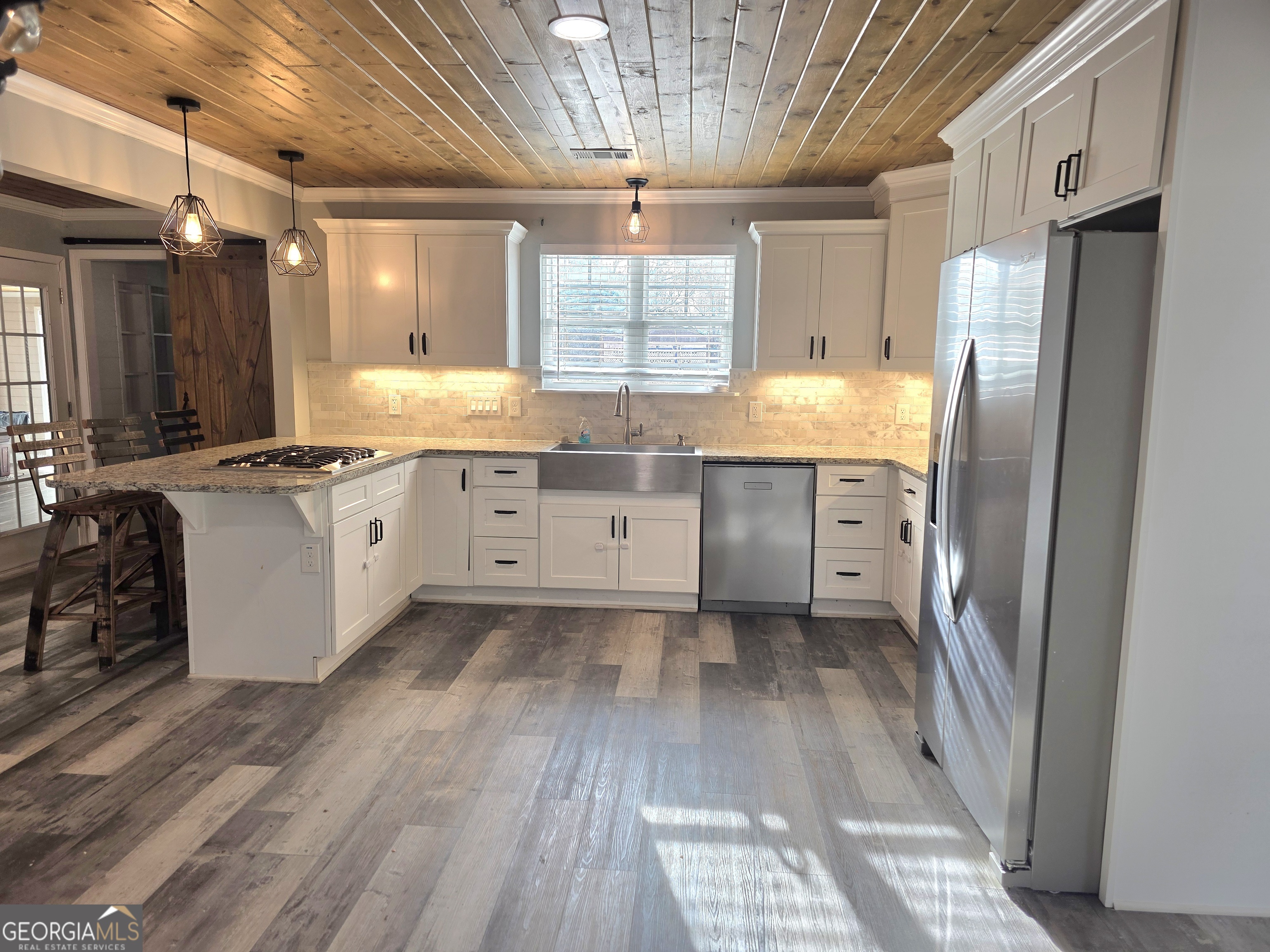 391 Price Street Statham, GA 30666 - Photo 6 of 41 a kitchen with granite countertop a sink a counter space appliances and cabinets