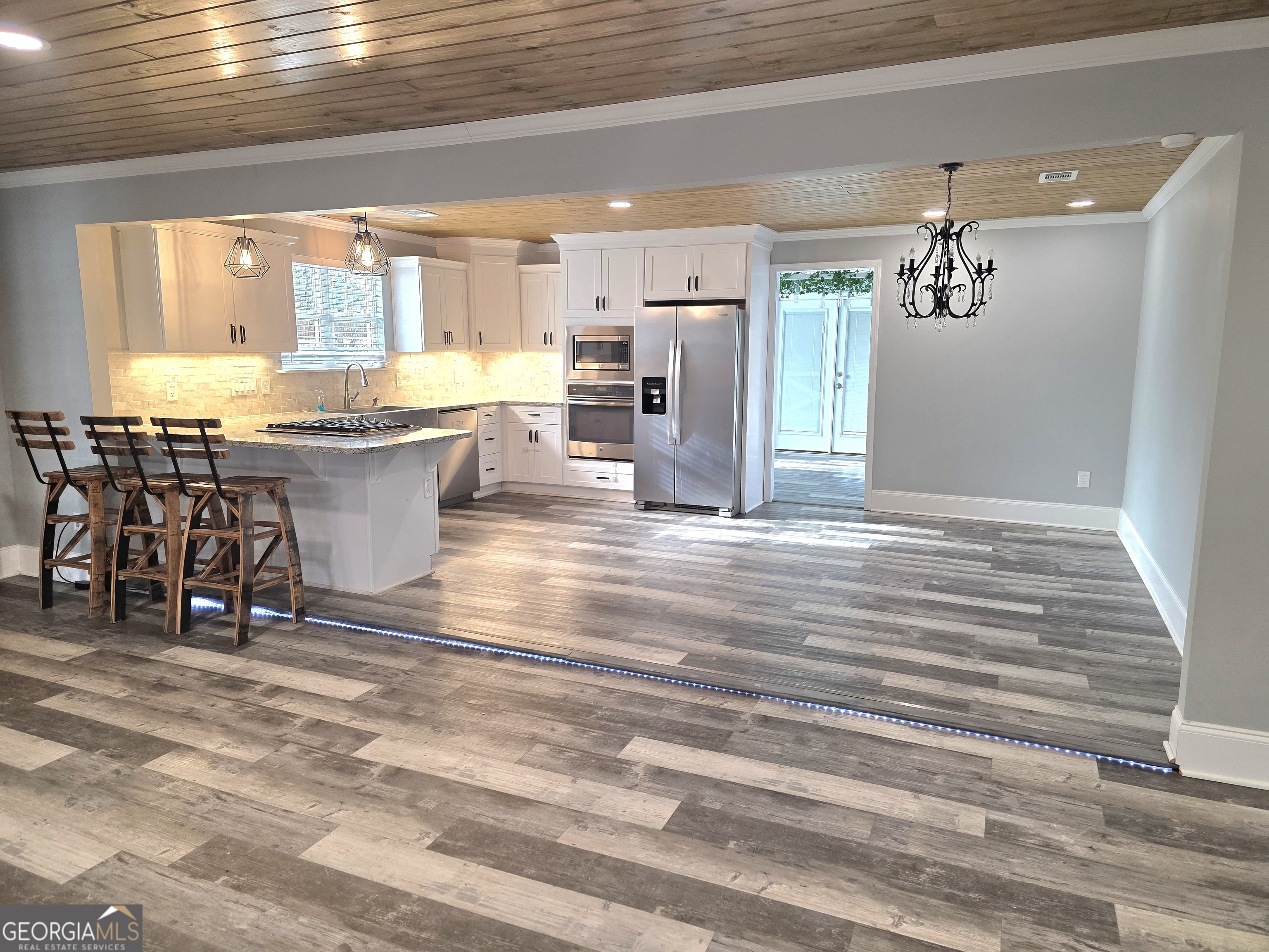 391 Price Street Statham, GA 30666 - Photo 9 of 41 a view of kitchen with granite countertop cabinets and outdoor view