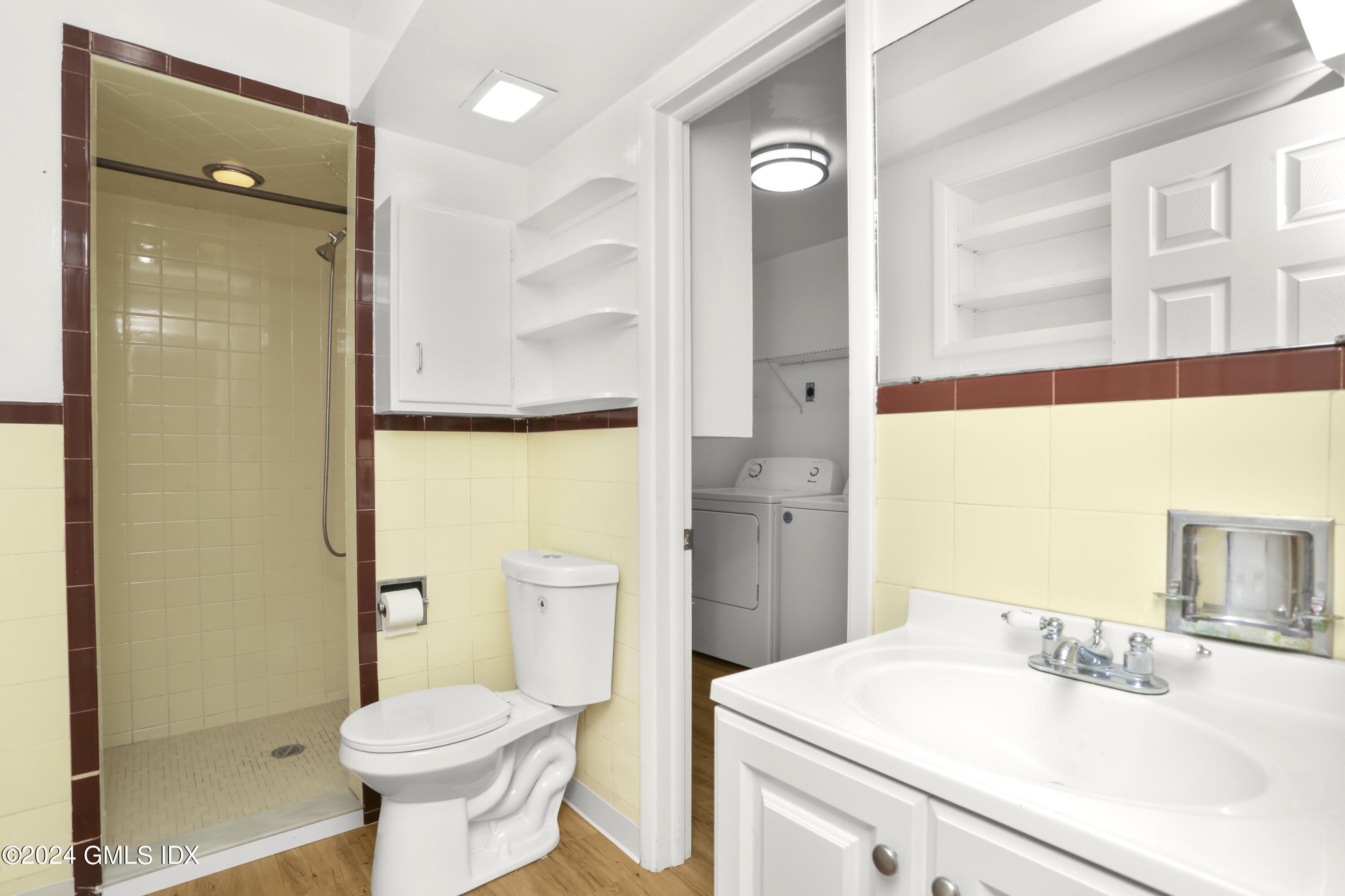 66 Arch Street Riverside, CT 06878 - Photo 19 of 30 a bathroom with a sink toilet vanity and shower