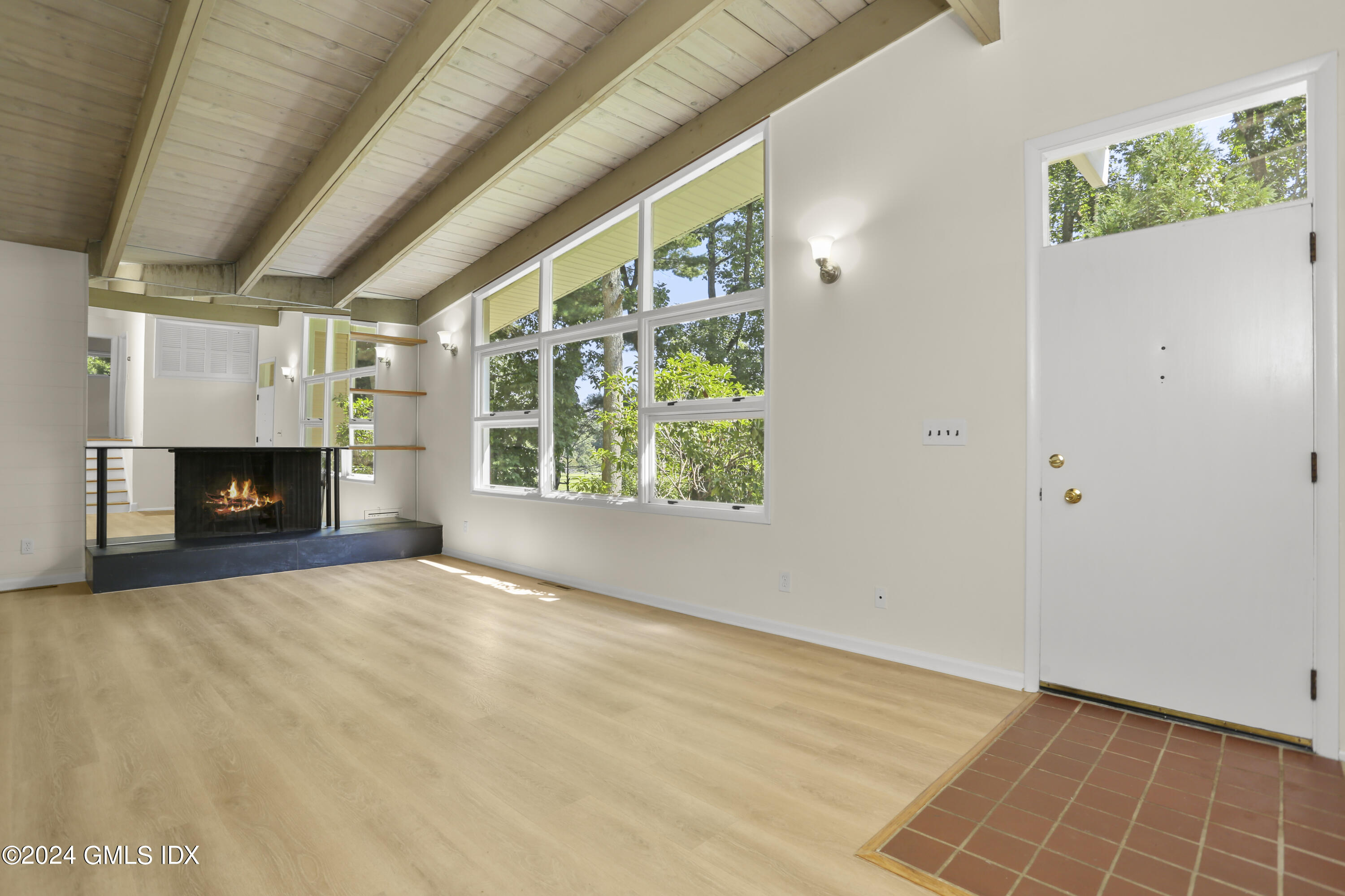 66 Arch Street Riverside, CT 06878 - Photo 5 of 30 an empty room with windows and fireplace