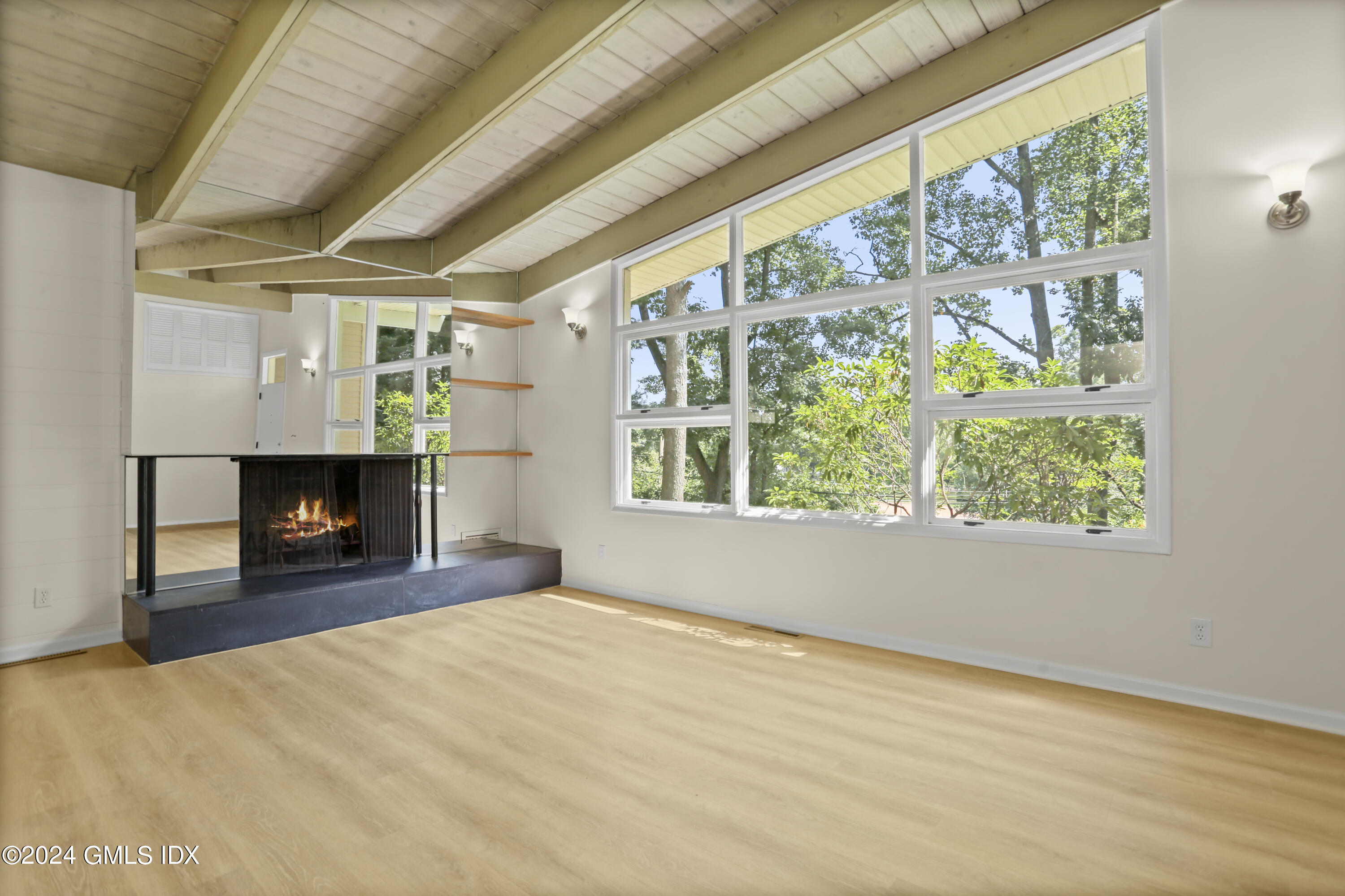 66 Arch Street Riverside, CT 06878 - Photo 6 of 30 a view of empty room with a fireplace and window