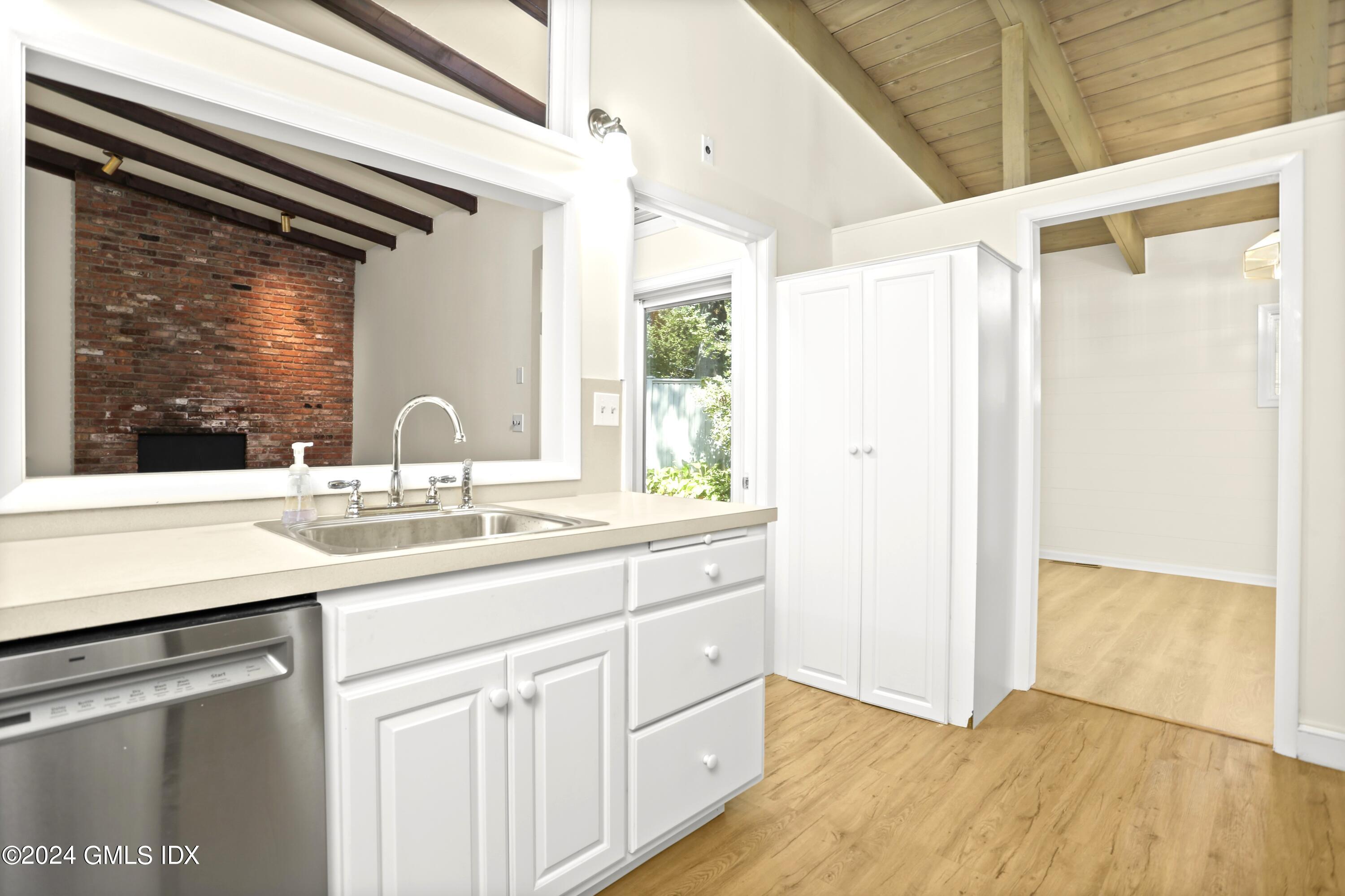 66 Arch Street Riverside, CT 06878 - Photo 8 of 30 a bathroom with a double vanity sink and mirror