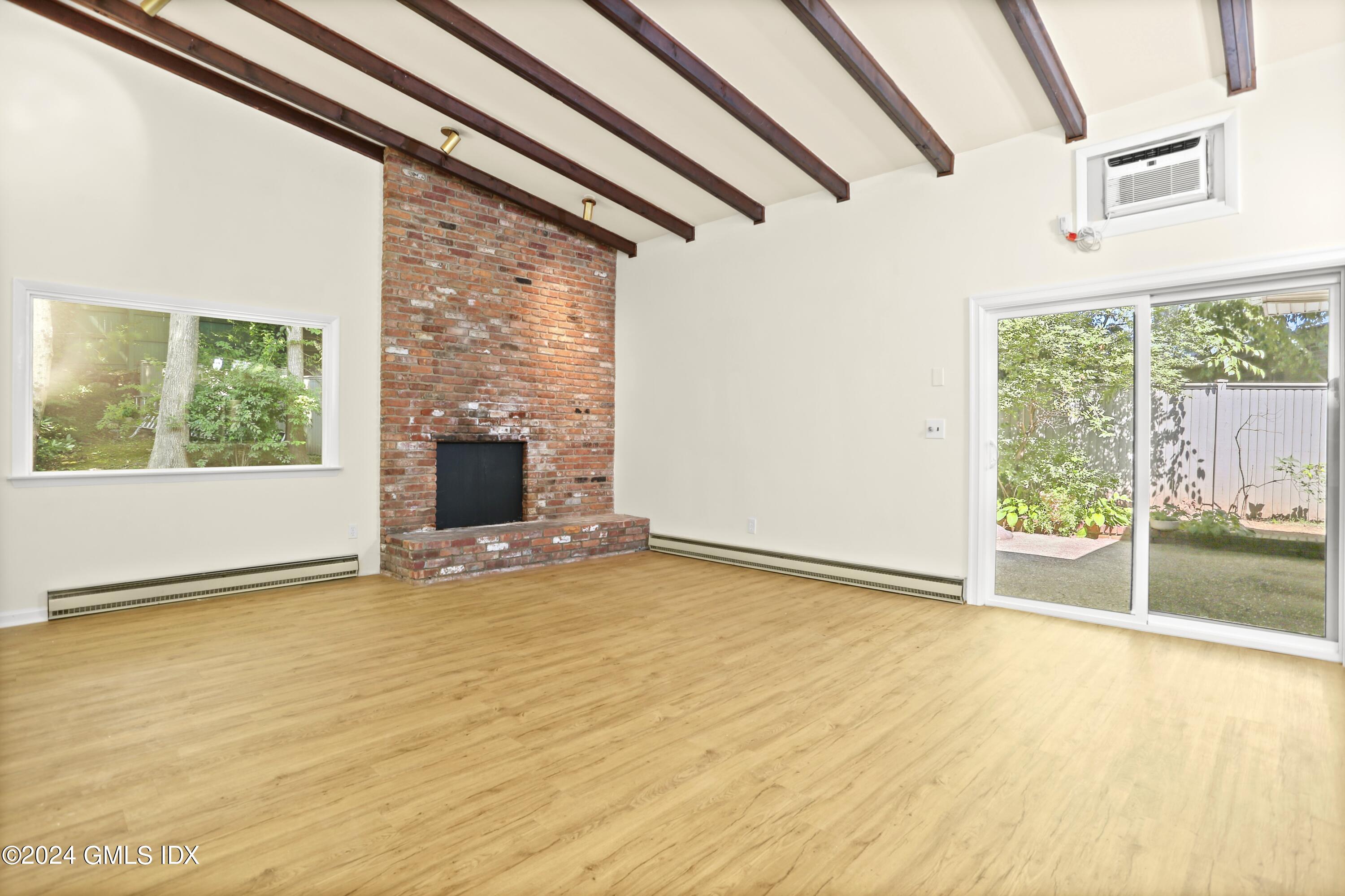 66 Arch Street Riverside, CT 06878 - Photo 10 of 30 a view of an empty room with a fireplace and a window