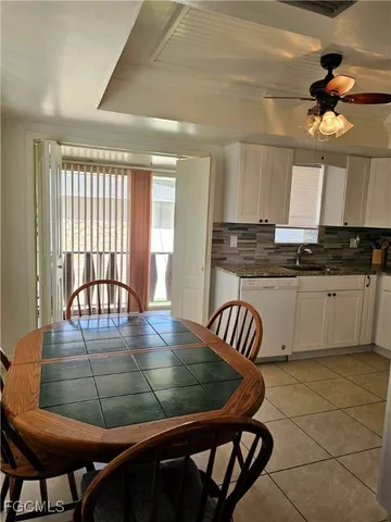 a kitchen with a table chairs and a dining table