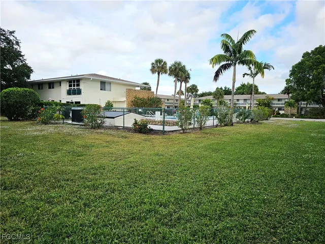 a view of a house with a yard and sitting area