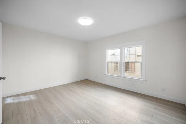 an empty room with furniture and a window