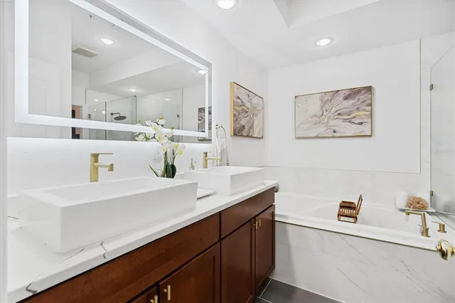 a view of cabinets a sink and a refrigerator in a room