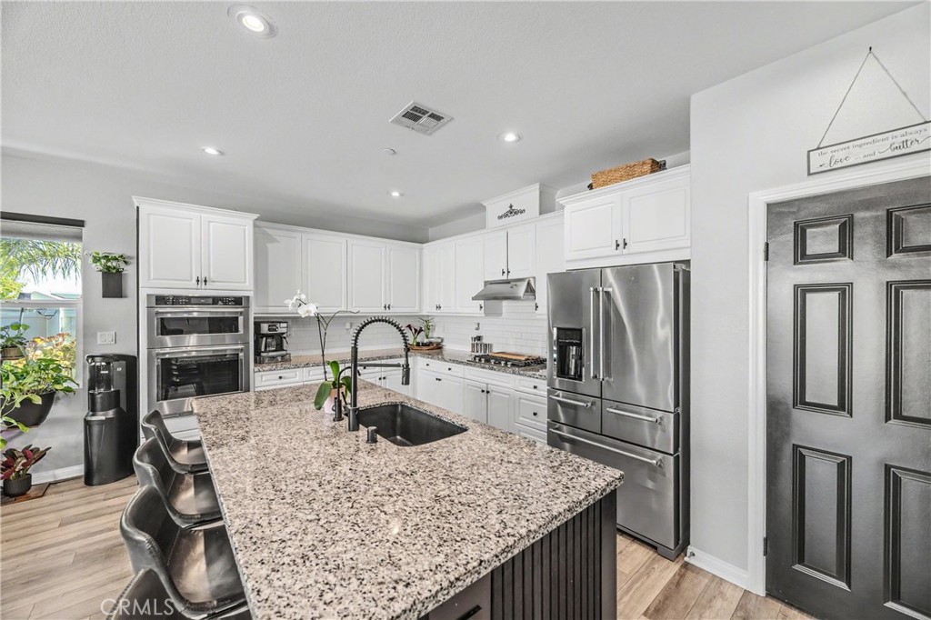 34512 Burnt Pine Road Murrieta, CA 92563 - Photo 2 of 21 a kitchen with refrigerator and cabinets