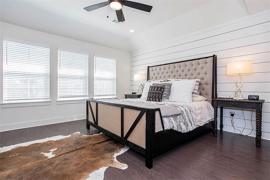 1311 Fort Branch Boulevard Austin, TX 78721 - Photo 17 of 27 Bedroom featuring ceiling fan, visible vents, baseboards, and wood finished floors