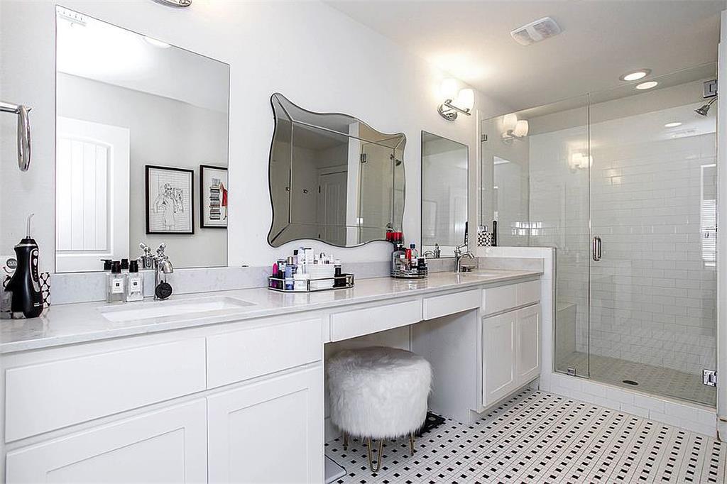 1311 Fort Branch Boulevard Austin, TX 78721 - Photo 18 of 27 Full bath with double vanity, visible vents, a shower stall, and a sink