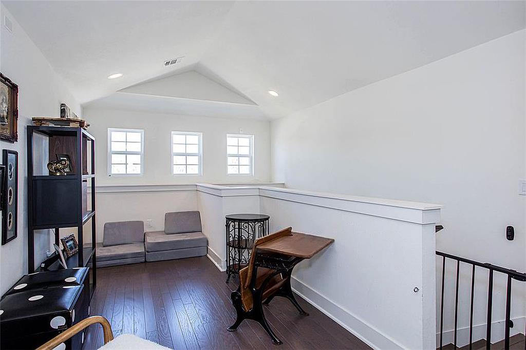 1311 Fort Branch Boulevard Austin, TX 78721 - Photo 20 of 27 Sitting room featuring hardwood / wood-style flooring, an upstairs landing, visible vents, and vaulted ceiling