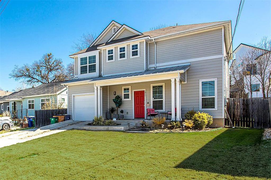 1311 Fort Branch Boulevard Austin, TX 78721 - Photo 2 of 27 Traditional-style home featuring a porch, fence, concrete driveway, a front yard, and a garage