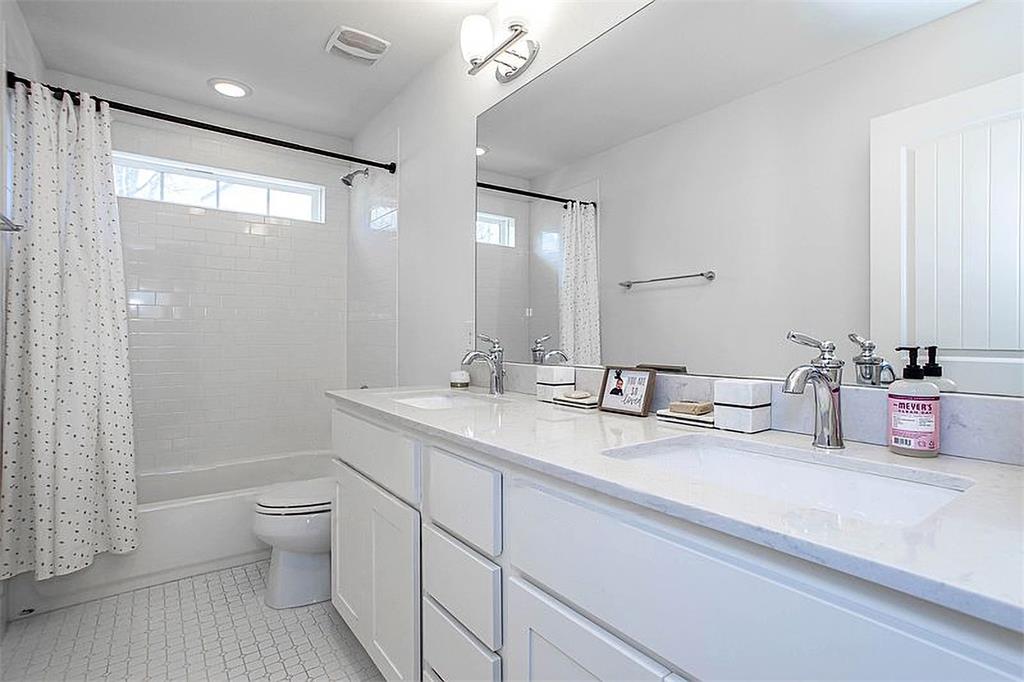 1311 Fort Branch Boulevard Austin, TX 78721 - Photo 24 of 27 Full bath with a sink, visible vents, toilet, and tile patterned flooring