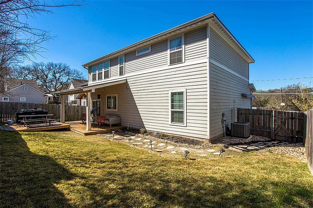 1311 Fort Branch Boulevard Austin, TX 78721 - Photo 26 of 27 Back of property featuring a lawn, cooling unit, a wooden deck, and fence