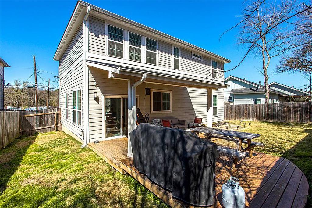 1311 Fort Branch Boulevard Austin, TX 78721 - Photo 27 of 27 Rear view of property with a wooden deck, a lawn, and a fenced backyard