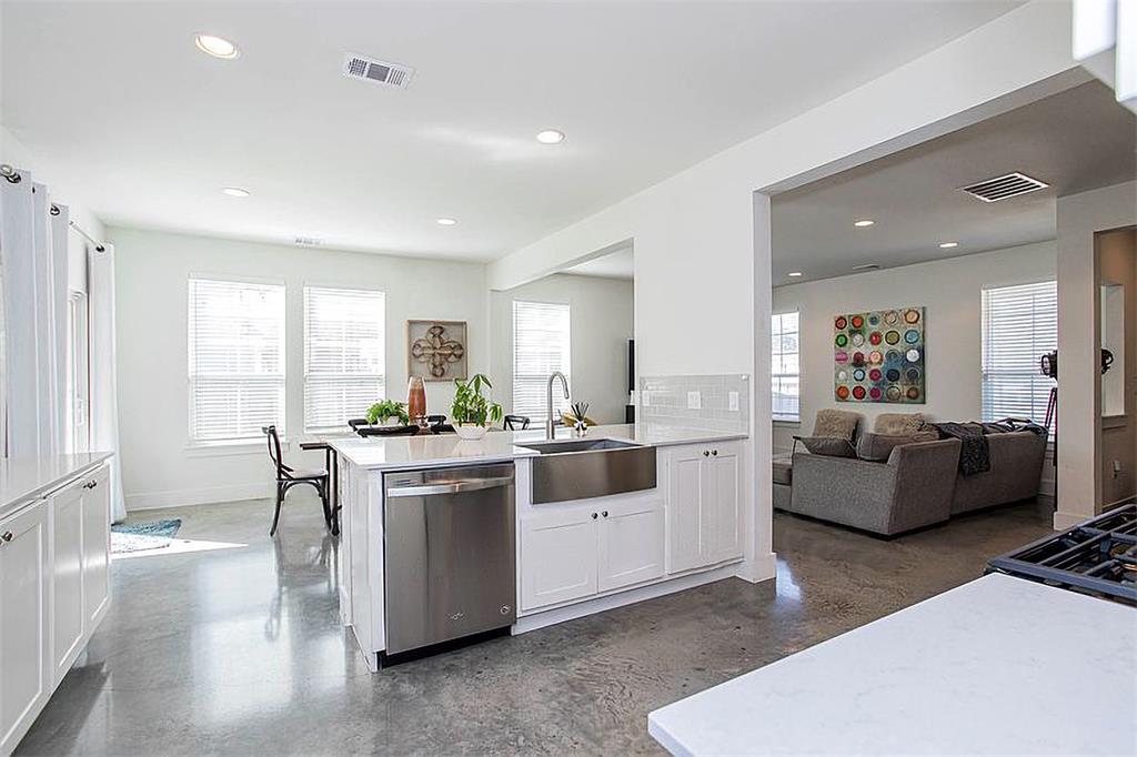 1311 Fort Branch Boulevard Austin, TX 78721 - Photo 10 of 27 Kitchen featuring a sink, visible vents, dishwasher, and light countertops