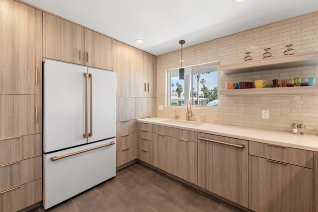 a white refrigerator freezer sitting inside of a kitchen