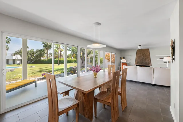 a view of a dining room with furniture large windows and wooden floor