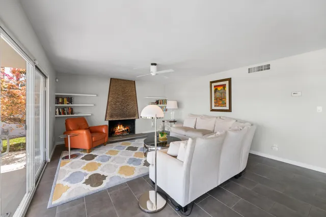 a living room with furniture fireplace and flat screen tv