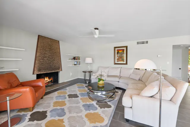 a living room with furniture and a lamp