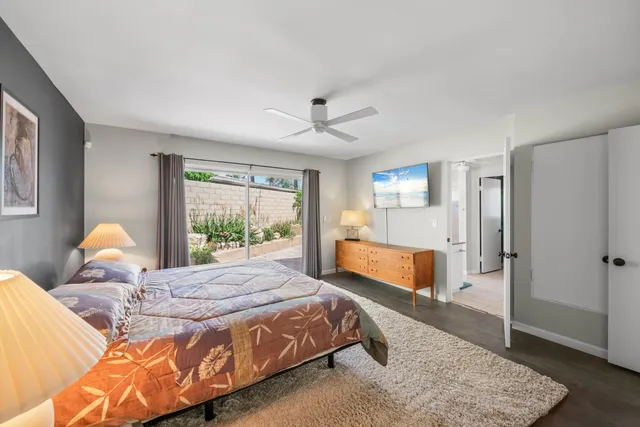 a spacious bedroom with a bed and a couch